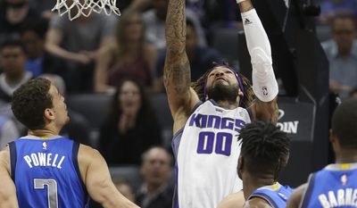 Sacramento Kings center Willie Cauley-Stein, center, grabs the ball between Dallas Mavericks&#39; Dwight Powell, left, and Nerlens Noel, second from right, during the first half of an NBA basketball game Tuesday, April 4, 2017, inSacramento, Calif. (AP Photo/Rich Pedroncelli)