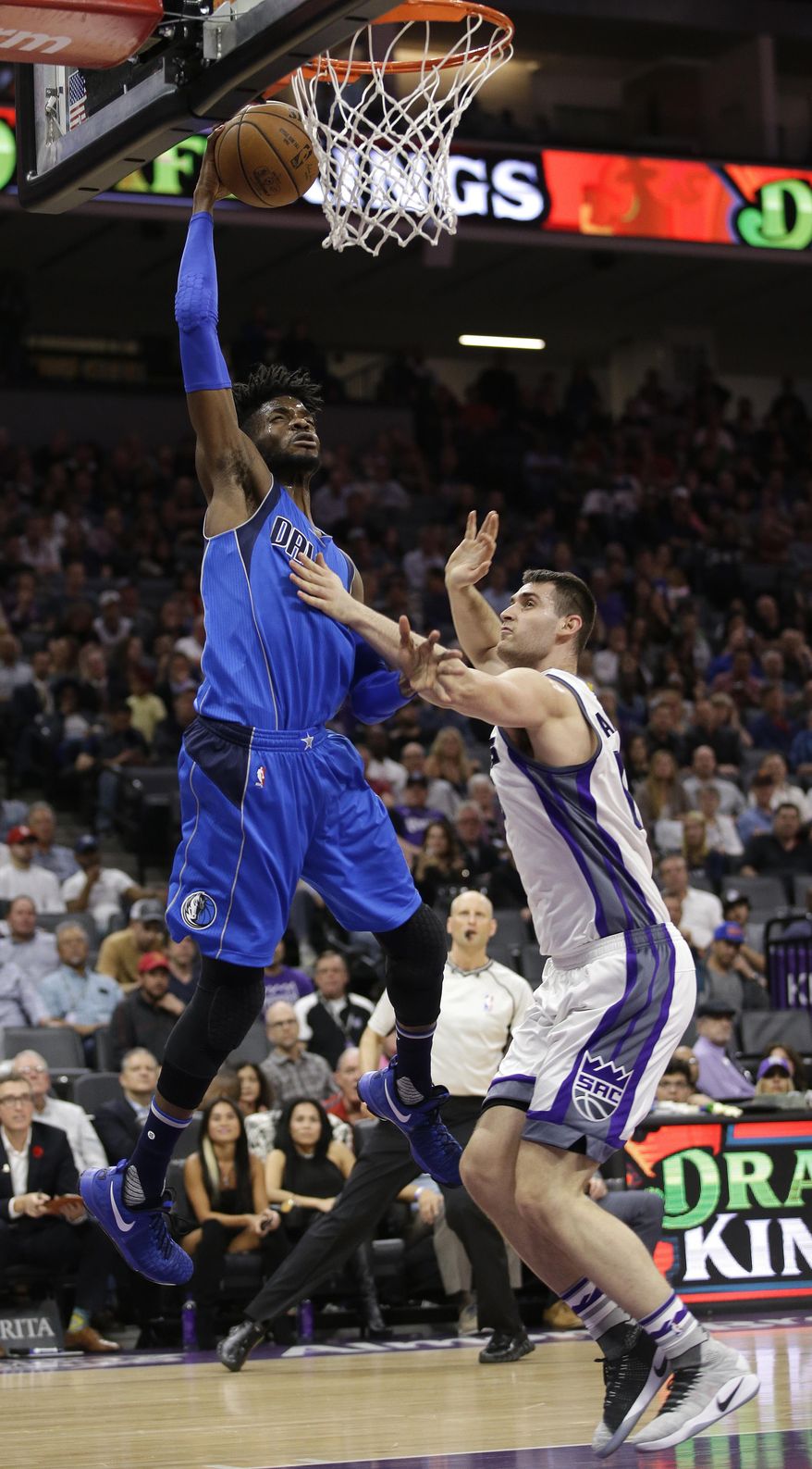 Dallas Mavericks forward Nerlens Noel, left, goes to the basket against Sacramento Kings center Georgios Papagiannis during the first half of an NBA basketball game Tuesday, April 4, 2017, in Sacramento, Calif. (AP Photo/Rich Pedroncelli)