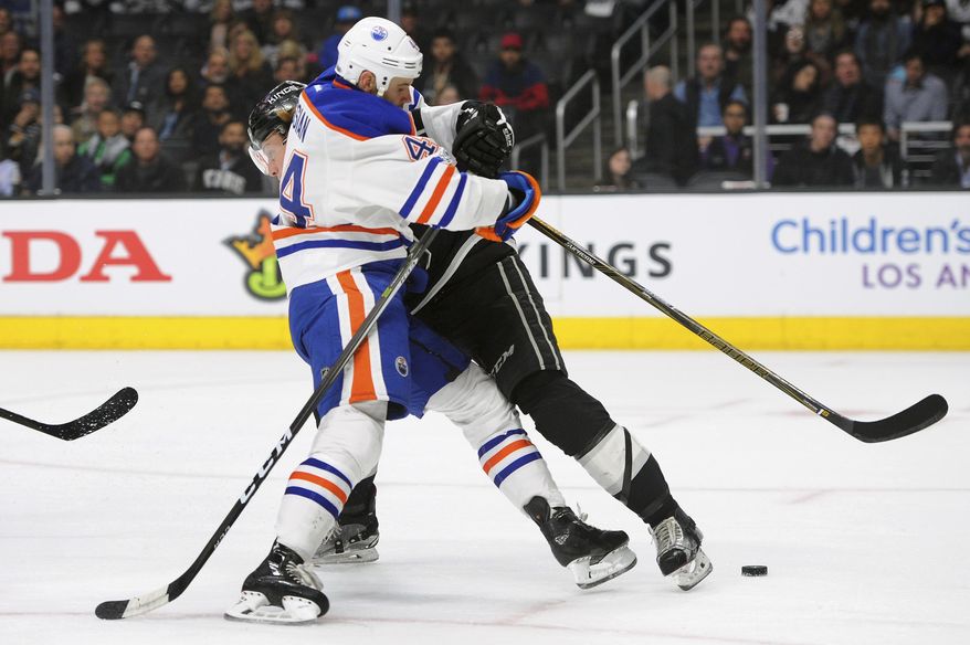 Edmonton Oilers right wing Zack Kassian (44) runs into Los Angeles Kings defenseman Paul LaDue in the first period of an NHL hockey game, Tuesday, April 4, 2017, in Los Angeles. (AP Photo/Michael Owen Baker)