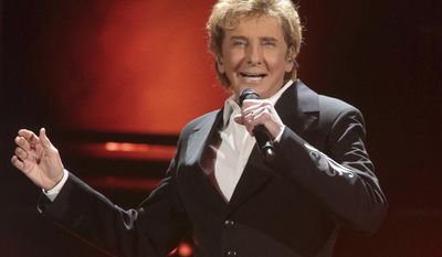 FILE - In this March 17, 2016 file photo, Barry Manilow performs in concert during his &amp;quot;One Last Time! Tour 2016&amp;quot; in Hershey, Pa. Manilow tells People magazine that he hid being gay for decades because he thought he would be “disappointing fans if they knew.” The 73-year-old music legend married his longtime manager, Gary Kief, in a 2014 ceremony at their home in Palm Springs, Calif. Manilow tells the magazine’s April 17 issue that keeping their romance out of the media was stressful. (Photo by Owen Sweeney/Invision/AP, File)