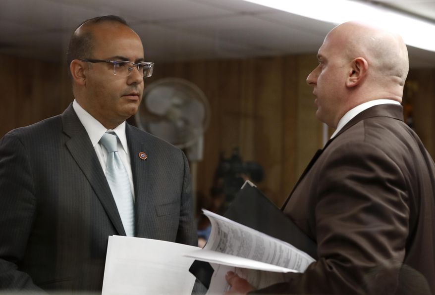 Hudson County Assistant Prosecutor Leo Hernandez, left, talks to John Appello, attorney for Michael Hansen, a Hudson County corrections officer, after a hearing charging Hansen with hit and run charges, Wednesday, April 5, 2017, in Jersey City, N.J. Hansen, who was scheduled to make the appearance via a video conference but could only do it through audio because of technical difficulties, is charged with leaving the scene of an accident in which Jersey City Republican Party Chairman Russell Maffei and Marie Tauro, a prospective legislative candidate, were allegedly struck and killed April 2, 2017, while crossing a street outside a diner in North Bergen, N.J. (AP Photo/Julio Cortez)