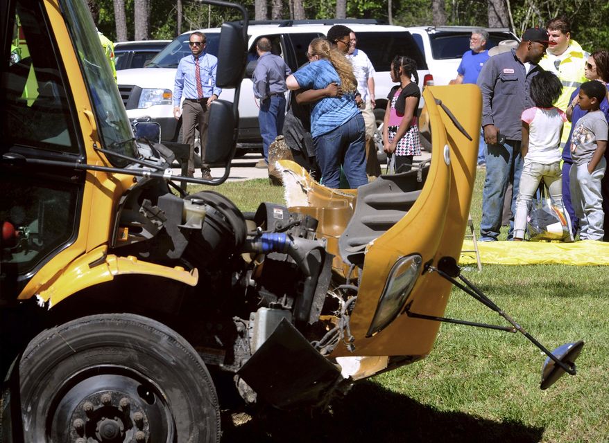 More than 20 Charlton-Pollard Elementary students and one adult were hospitalized when a Beaumont school district bus was involved in a traffic accident on U.S. 69 in Lumberton, Texas, Wednesday, April 5, 2017. The bus was taking several dozen Charlton-Pollard Elementary School students and several adults back to school from a Big Thicket field trip. Officials had no information on how the accident happened, but photos showed the bus veered off the road, through a roadside ditch and into a rock. (Guiseppe Barranco/The Beaumont Enterprise via AP)