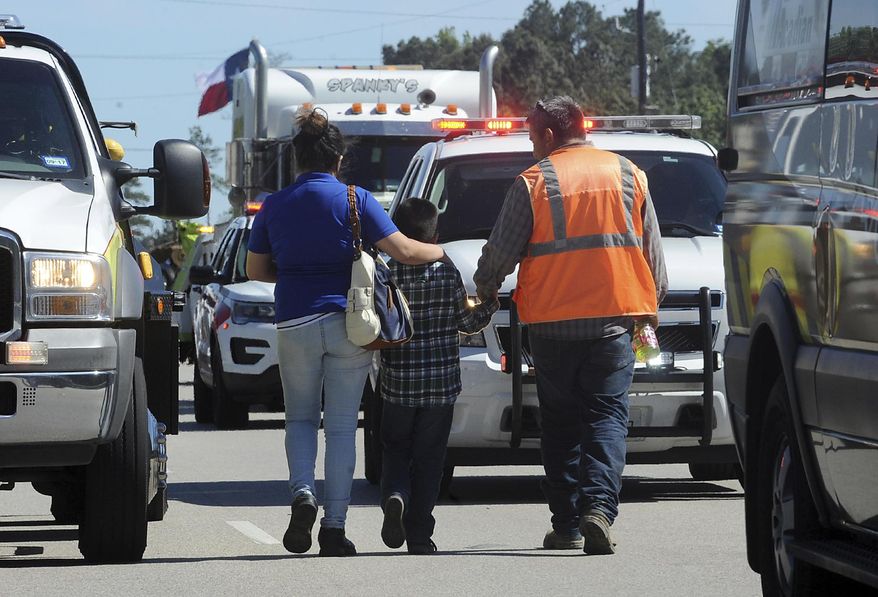 More than 20 Charlton-Pollard Elementary students and one adult were hospitalized when a Beaumont school district bus was involved in a traffic accident on U.S. 69 in Lumberton, Texas, Wednesday, April 5, 2017. The bus was taking several dozen Charlton-Pollard Elementary School students and several adults back to school from a Big Thicket field trip. Officials had no information on how the accident happened, but photos showed the bus veered off the road, through a roadside ditch and into a rock. (Guiseppe Barranco/The Beaumont Enterprise via AP)