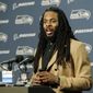 FILe - In this Jan. 7, 2017, file photo, Seattle Seahawks cornerback Richard Sherman talks to reporters following an NFL football NFC wild card playoff game against the Detroit Lions, in Seattle. Seahawks general manager John Schneider acknowledged the team has listened to trade offers regarding cornerback Richard Sherman, but downplayed that a deal may actually happen. Schneider made his comments in an interview with KIRO-AM on Wednesday, April 5, 2017. (AP Photo/Stephen Brashear, File)