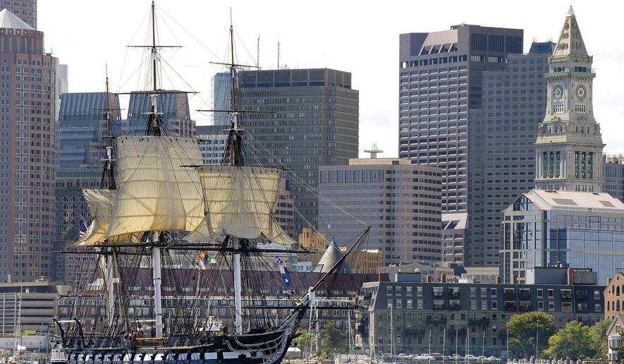 FILE - In this Aug. 29, 2014, file photo, the USS Constitution is towed through Boston Harbor past Boston's financial district skyline with its topsails unfurled. The warship nicknamed Old Ironsides, the world's oldest commissioned ship still afloat, is nearing the end of a two-year restoration in dry dock at the Charlestown Navy Yard. It is slated to return to the waters in late July 2017. (AP Photo/Stephan Savoia, File)