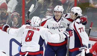 FILE- In this Jan. 7, 2017, file photo, Washington Capitals&#x27; T.J. Oshie (77) celebrates his goal with teammates Nicklas Backstrom (19) and Alex Ovechkin (8) during the first period of an NHL hockey game against the Ottawa Senators in Ottawa. Oshie has shown to be the perfect complement for Ovechkin and Backstrom and has the potential to be the X-factor for Washington in the playoffs. (Fred Chartrand/The Canadian Press via AP, File)