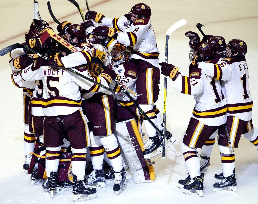 Minnesota-Duluth players celebrate after they defeated Harvard 2-1 during an NCAA Frozen Four men's college hockey semifinal, Thursday, April 6, 2017, in Chicago. (AP Photo/Nam Y. Huh)