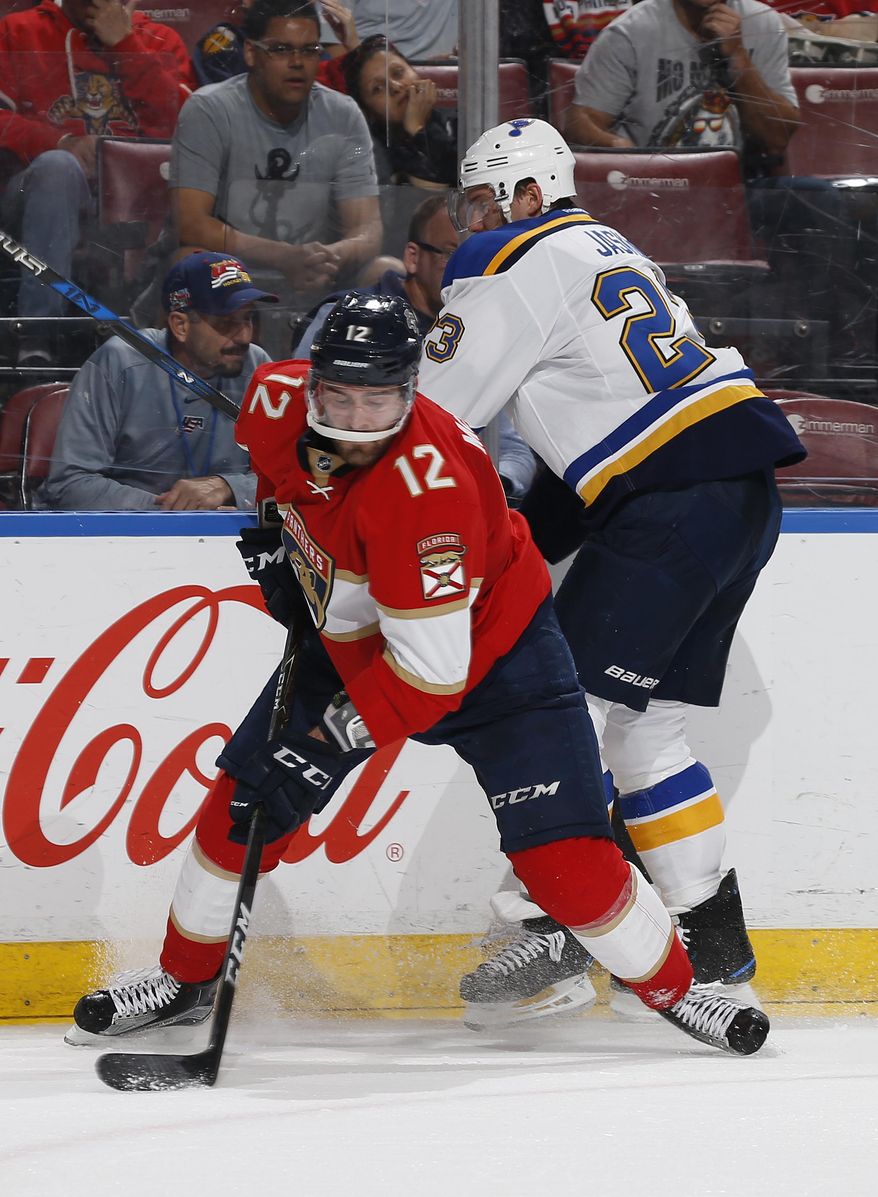 Florida Panthers defenseman Ian McCoshen (12) takes the puck from St. Louis Blues right wing Dmitrij Jaskin (23) after checking him during the second period of an NHL hockey game, Thursday, April 6, 2017, in Sunrise, Fla. (AP Photo/Joel Auerbach)