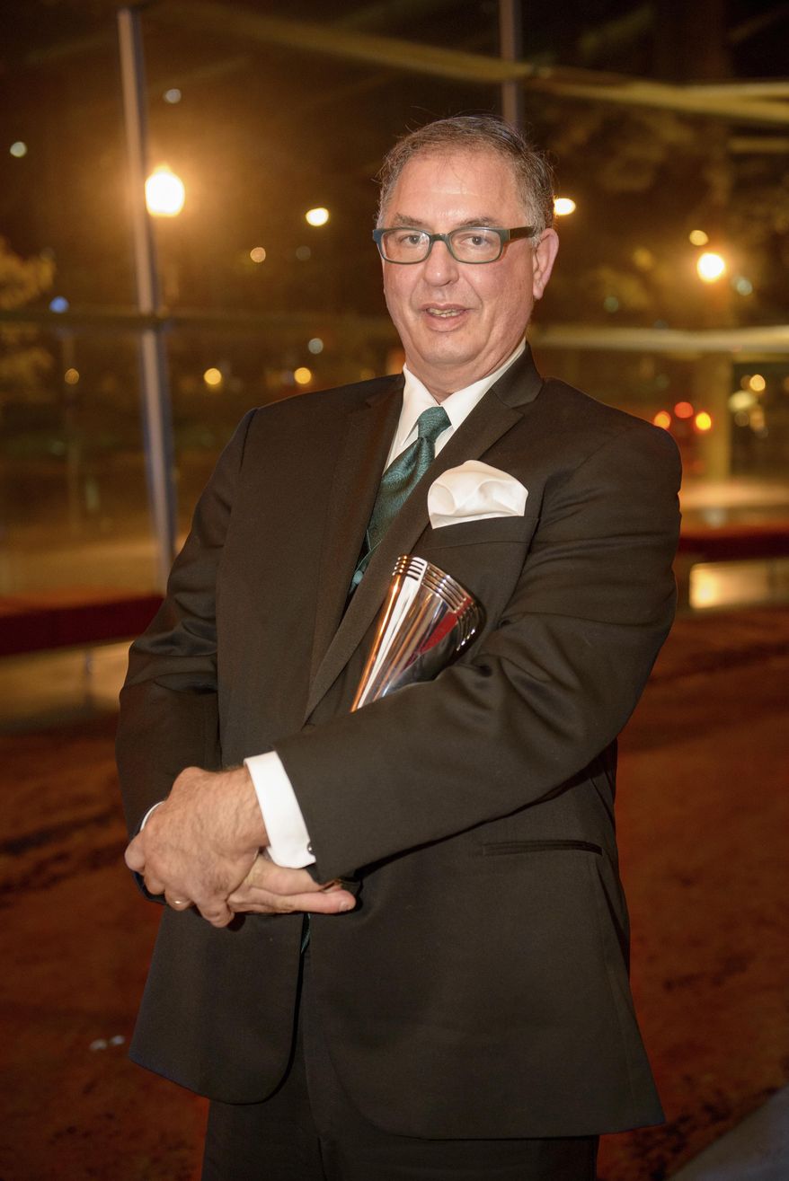 ADVANCE FOR USE MONDAY, APRIL 10, 2017 AT 1 A.M. EDT AND THEREAFTER-In this Sept. 21, 2013 photo provided by the BAM Education Awards, Deven Black holds his Bam!E prize for top school librarian in the country, at an awards ceremony in Washington, D.C. The path that took Black from suburban New York dad and nationally recognized school librarian to a room in a gritty homeless shelter - and to a bloody death at the hands of his roommate - was as baffling as it was tragic. (BAM Education Awards via AP)
