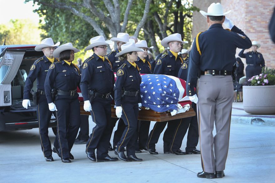 The body of Harris County assistant chief deputy constable Clint Greenwood arrives at the Second Baptist Church on Thursday, April 6, 2017, in Houston. Greenwood was killed Monday by a gunman who stepped out from behind a dumpster as Greenwood arrived for work at a county courthouse east of Houston. The gunman is still on the run. (Steve Gonzales/Houston Chronicle via AP)