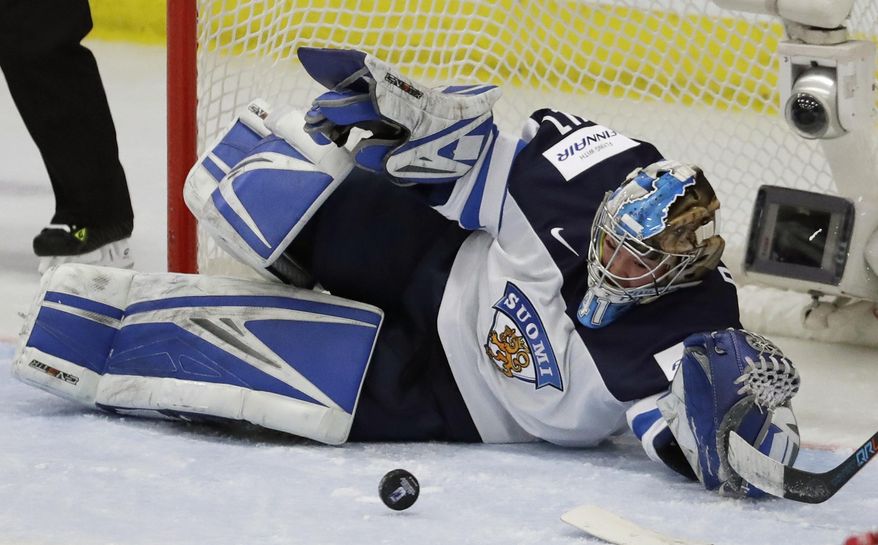 Finland goalie Noora Raty deflects a shot during the first period of an IIHF women&#x27;s world hockey championship semifinal game against Canada on Thursday, April 6, 2017, in Plymouth, Mich. (AP Photo/Carlos Osorio)