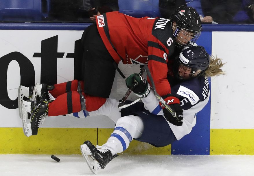 Canada forward Rebecca Johnston (6) hits Finland defender Anna Kilponen (5) during the second period of an IIHF women&#x27;s world hockey championship semifinal game Thursday, April 6, 2017, in Plymouth, Mich. (AP Photo/Carlos Osorio)