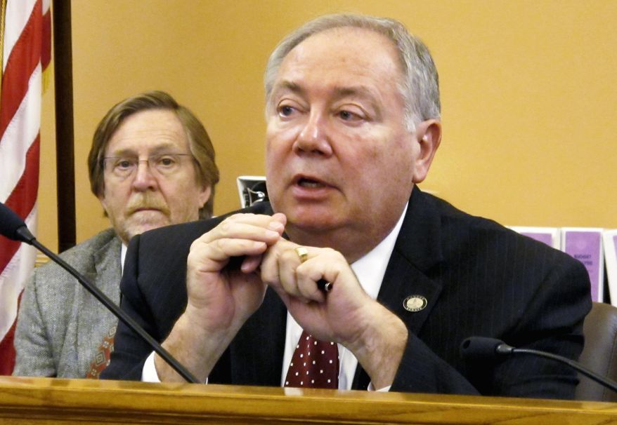 Kansas Senate Majority Leader Jim Denning, R-Overland Park, discusses tax issues during a caucus for GOP senators ahead of a debate over income tax legislation, Thursday, April 6, 2017, at the Statehouse in Topeka, Kan. Lawmakers are considering a proposal to raise new revenue to fix the state's budget problems with a "flat" personal income tax. (AP Photo/John Hanna)