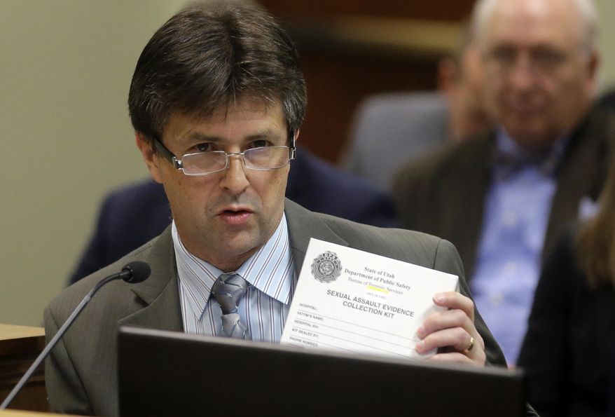 This Feb. 8, 2017, photo, Utah State Crime Lab Director Jay Henry holds a sexual assault evidence collection kit as he speaks during committee meeting at the state Capitol in Salt Lake City. Utah crime lab officials are feeling optimistic as they work to speed up the time it takes to process sexual assault evidence kits, after lawmakers approved a measure last month that sends more than $1 million to go toward this effort. (AP Photo/Rick Bowmer)
