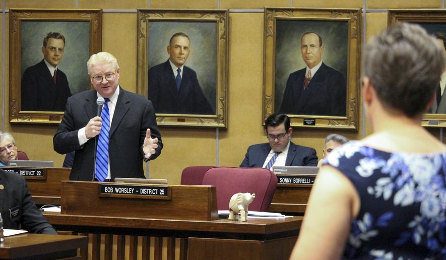 In this file photo, Republican state Sen. Bob Worsley, left, answers a question from Democratic Sen. Katie Hobbs, foreground, during an Arizona Senate debate on a proposal to expand Arizona's private school voucher program to all students Thursday, April 6, 2017, in Phoenix. On August 8, AP reported that the law was put on hold as enough signatures had been received by the state to put the question up to voters in 2018 as a ballot referendum. (AP Photo/Bob Christie)