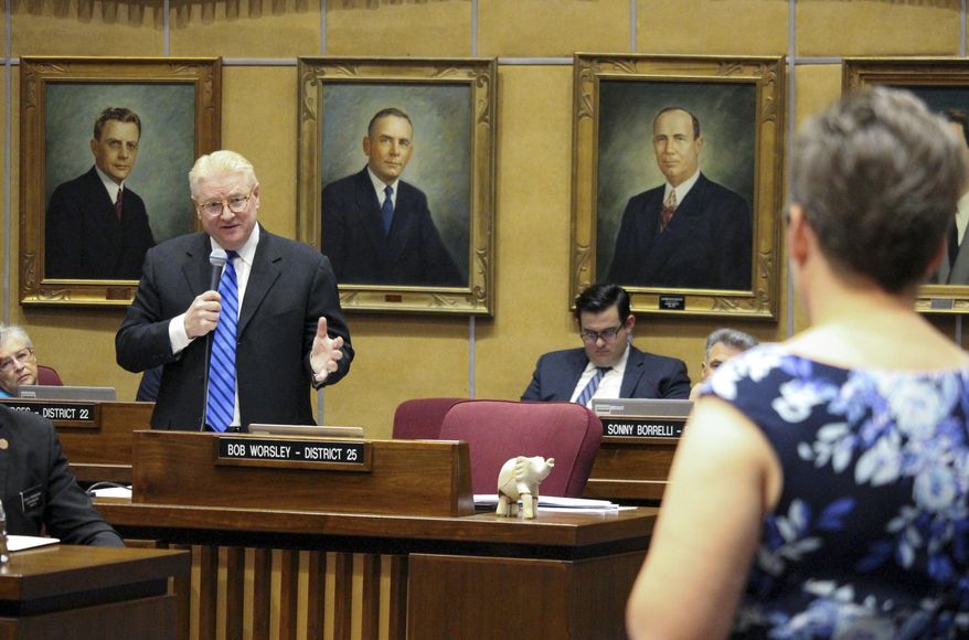 In this file photo, Republican state Sen. Bob Worsley, left, answers a question from Democratic Sen. Katie Hobbs, foreground, during an Arizona Senate debate on a proposal to expand Arizona's private school voucher program to all students Thursday, April 6, 2017, in Phoenix. On August 8, AP reported that the law was put on hold as enough signatures had been received by the state to put the question up to voters in 2018 as a ballot referendum. (AP Photo/Bob Christie)