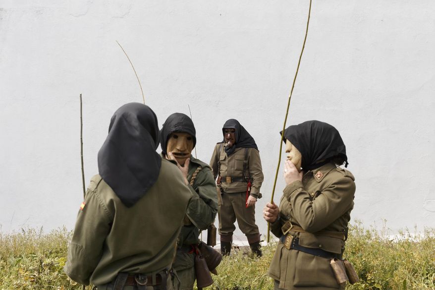 In this April 1, 2017 picture revelers from San Pedro Bernardo village wearing the traditional 'Machurrero' mask and outfit parade during a gathering of different villages' carnival masks and characters in the small village of Casavieja, Spain, Monday, April 3, 2017. (AP Photo/Daniel Ochoa de Olza)