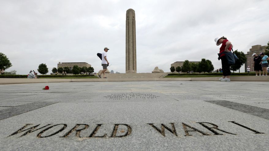 FILE - In this May 26, 2014 file photo, visitors look at memorial bricks after a Memorial Day observance at the National World War Museum at Liberty Memorial in Kansas City, Mo. Foreign dignitaries from around the globe are converging on Kansas City, Missouri, and its towering World War I monument to observe the centennial of the day the U.S. entered "The Great War." A sellout gathering of 3,000 onlookers also have snapped up tickets for the daylong observance Thursday, April 6, 2017, titled "In Sacrifice for Liberty and Peace." (AP Photo/Charlie Riedel, File)