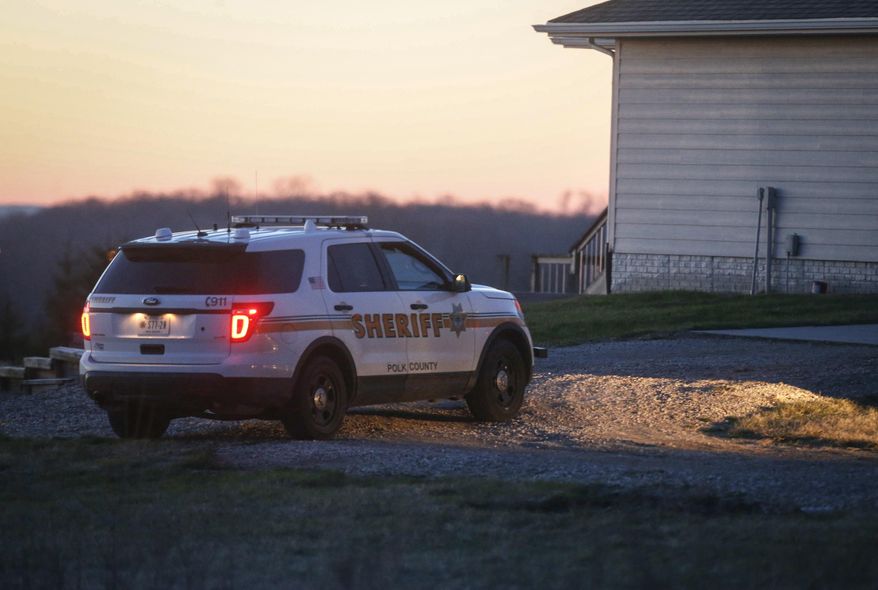 Investigators are work the scene in rural Bondurant, Iowa, where three bodies were found in a home overnight on Friday, April 7, 2017. Deputies are searching for a man as a person of interest but who has not been charged. (Bryon Houlgrave/The Des Moines Register via AP )