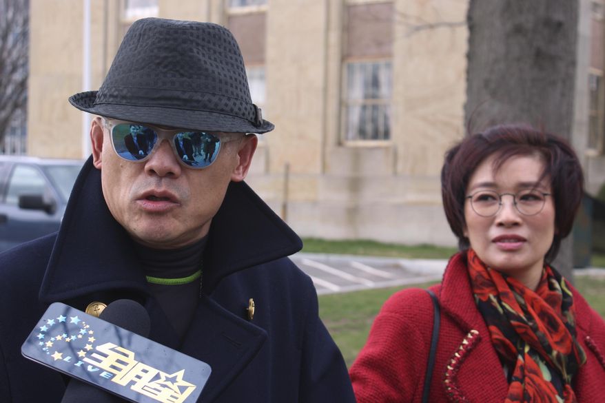 Chinese comedian Zhou Libo arrives with his wife Hu Jie at court in Mineola, N.Y., on Long Island where Zhou pleaded not guilty to drug and weapon charges. The comedian and former judge on the "China's Got Talent" television program was arrested during a traffic stop Jan. 19 in Lattingtown, east of New York City. Police said he had been driving erratically and when they stopped him said they noticed a shoulder holster in the back seat and found a loaded pistol and two plastic bags containing crack cocaine in a backpack. (AP Photo/Frank Eltman)