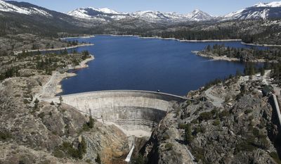 In this April 3 2017 photo, snow covering the Sierra Nevadas is seen in the background of the PG&amp;amp;E hydroelectric dam at Spaulding Lake in Nevada County, Calif. Gov. Jerry Brown declared an end to California&#39;s historic drought Friday, April 7, 2017, lifting emergency orders that had forced residents to stop running sprinklers as often and encouraged them to rip out thirsty lawns during the state&#39;s driest four-year period on record. (AP Photo/Rich Pedroncelli)
