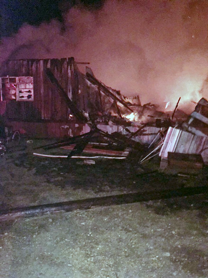 This photo provided by Damon Lowe of the Henry County Sheriff's Office, shows a house on fire in the early morning hours Friday, April 7, 2017, in Buchanan, Tenn. A Tennessee sheriff says a 13-year-old girl saved her 8-year-old sister's life in a fire at their home that killed five family members. At a news conference Friday, Henry County Sheriff Monte Belew called 13-year-old Lilly Pollack and 8-year-old Rose Pollack heroes for their action in the fire. (Damon Lowe/Henry County Sheriff's Office via AP)