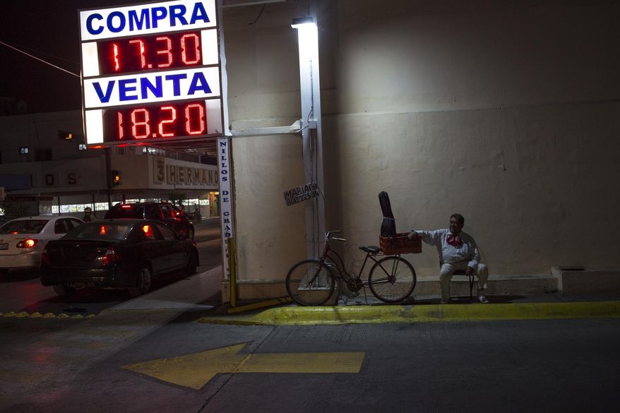 In this March 24, 2017 photo, a musician sits on a chair on a well-known street where Mariachis gather to be contracted in Nuevo Laredo, Mexico. (AP Photo/Rodrigo Abd)