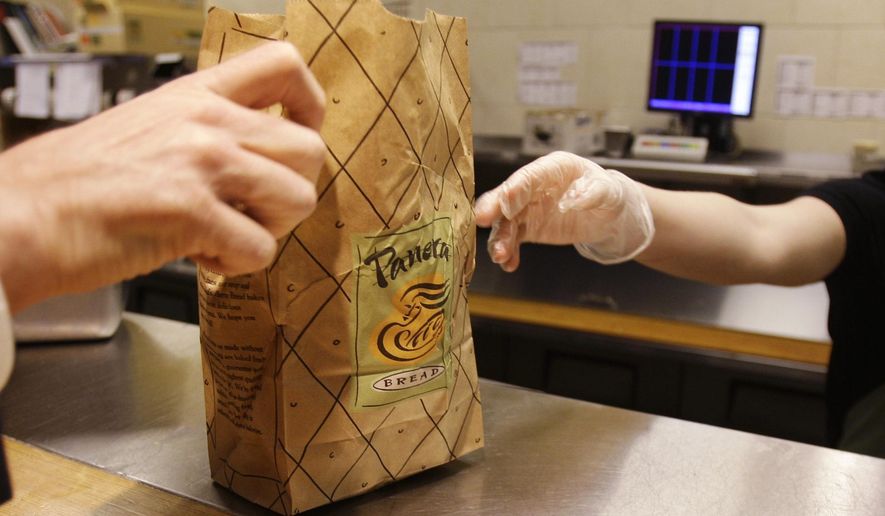 In this March 8, 2010, file photo, an employee passes an order to a customer at a Panera Bread store in Brookline, Mass. (AP Photo/Charles Krupa, File)