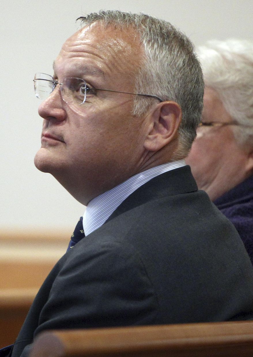 FILE - In this April 23, 2014 file photo, Monsignor Edward Arsenault looks back before pleading guilty to three felony theft charges in Hillsborough County Superior court in Manchester, N.H. The Diocese of Manchester said Friday, April 7, 2017, that Pope Francis dismissed Arsenault from the priesthood on Feb. 28. Arsenault is serving a jail sentence after he was convicted of stealing thousands of dollars from a hospital, a bishop and a deceased priest's estate. (AP Photo/Jim Cole, File)