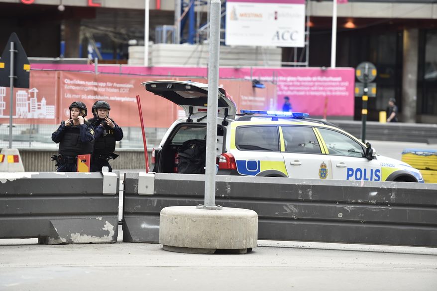 Police attend the scene after a truck crashed into a department store injuring several people in central Stockholm, Sweden, Friday April 7, 2017. (Noella Johansson, TT News Agency via AP)