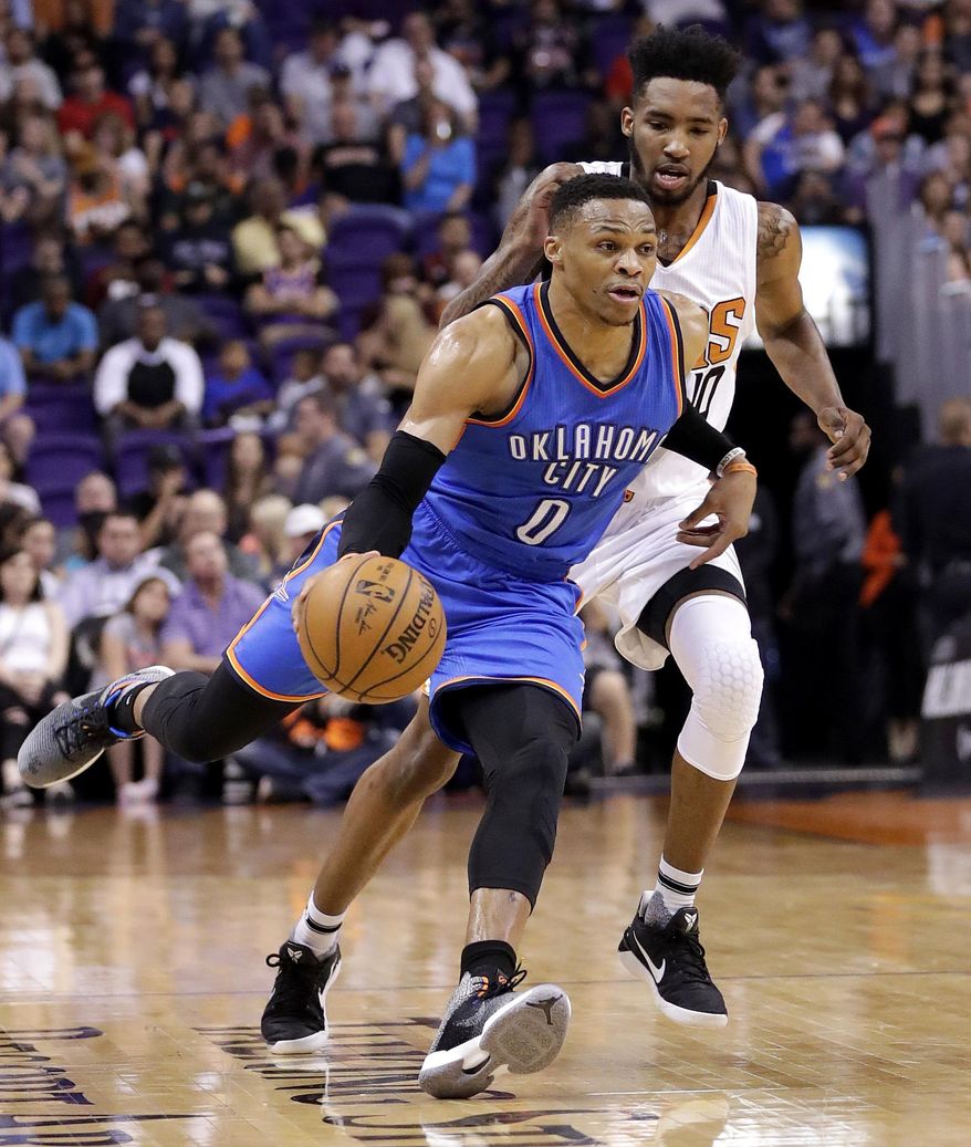 Oklahoma City Thunder guard Russell Westbrook (0) drives past Phoenix Suns forward Derrick Jones Jr. (10) during the first half of an NBA basketball game, Friday, April 7, 2017, in Phoenix. (AP Photo/Matt York)