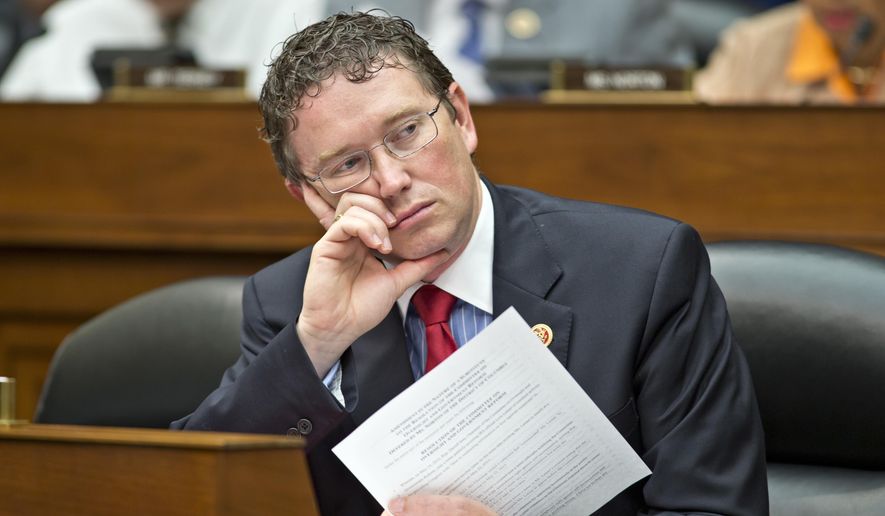 FILE - In this June 28, 2013, file photo, Rep. Thomas Massie, R-Ky., listens during a House Oversight Committee hearing on Capitol Hill in Washington. A vocal group of congressional Republicans, including Massie, and Democrats are reprimanding President Donald Trump for launching the cruise missile attack against Syria without first getting Capitol Hill’s approval. (AP Photo/J. Scott Applewhite, File) **FILE**