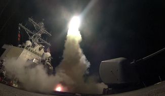 In this image provided by the U.S. Navy, the guided-missile destroyer USS Porter (DDG 78) launches a tomahawk land attack missile in the Mediterranean Sea, Friday, April 7, 2017. The United States blasted a Syrian air base with a barrage of cruise missiles in fiery retaliation for this week&#39;s gruesome chemical weapons attack against civilians.  (Mass Communication Specialist 3rd Class Ford Williams/U.S. Navy via AP)