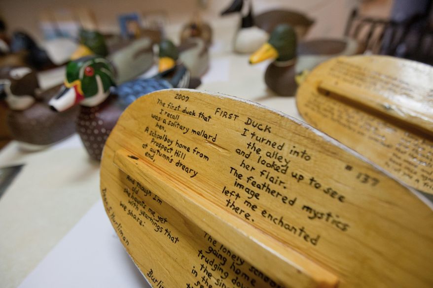 Many of Dean Hurliman's decoys have original poems wood burned onto the bottom of the pieces. This one titled: "First Duck," shown here on Monday, March 27, 2017 at his home in rural Burlington, Iowa. (Ben Roberts/The Hawk Eye via AP)