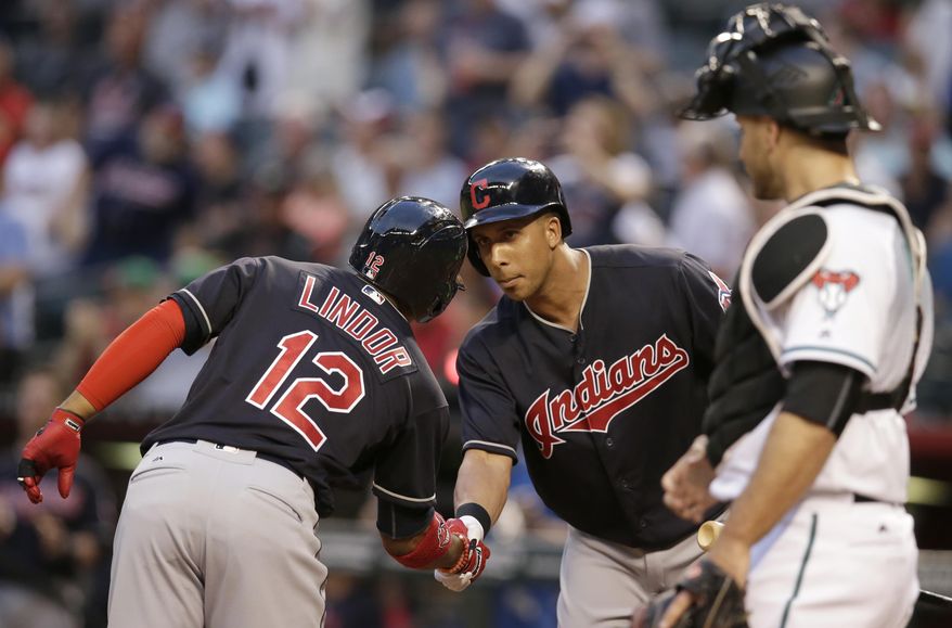 Cleveland Indians shortstop Francisco Lindor (12) celebrates with Michael Brantley after hitting a solo home run against the Arizona Diamondbacks in the first inning during a baseball game, Friday, April 7, 2017, in Phoenix. (AP Photo/Rick Scuteri)