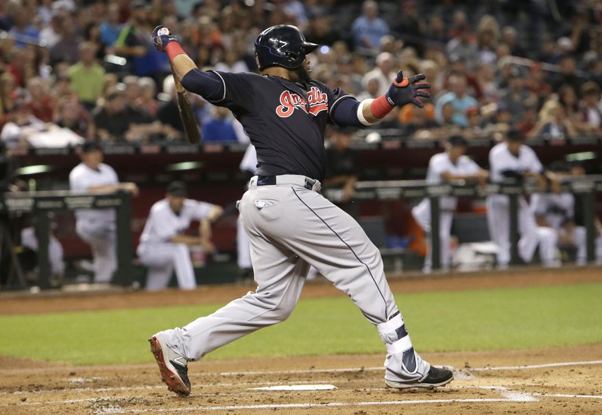 Cleveland Indians designated hitter Carlos Santana hits a two-run single against the Arizona Diamondbacks in the second inning during a baseball game, Friday, April 7, 2017, in Phoenix. (AP Photo/Rick Scuteri)