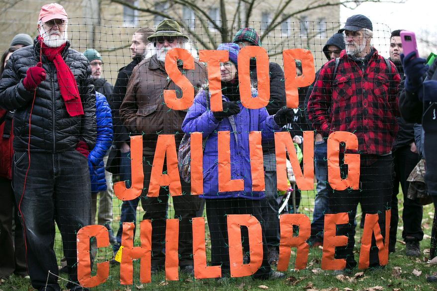 In this Jan. 11, 2017 photo, plans to build a new, $210 million juvenile-justice center and lockup in Seattle are met with opposition by protesters, in Seattle. For the past 20 years, it’s been up to county prosecutors across the state to decide which 16- and 17-year-olds accused of committing certain violent crimes are “auto declined” to adult, or superior, court and which ones are prosecuted in the juvenile system. (Johnny Andrews /The Seattle Times via AP)