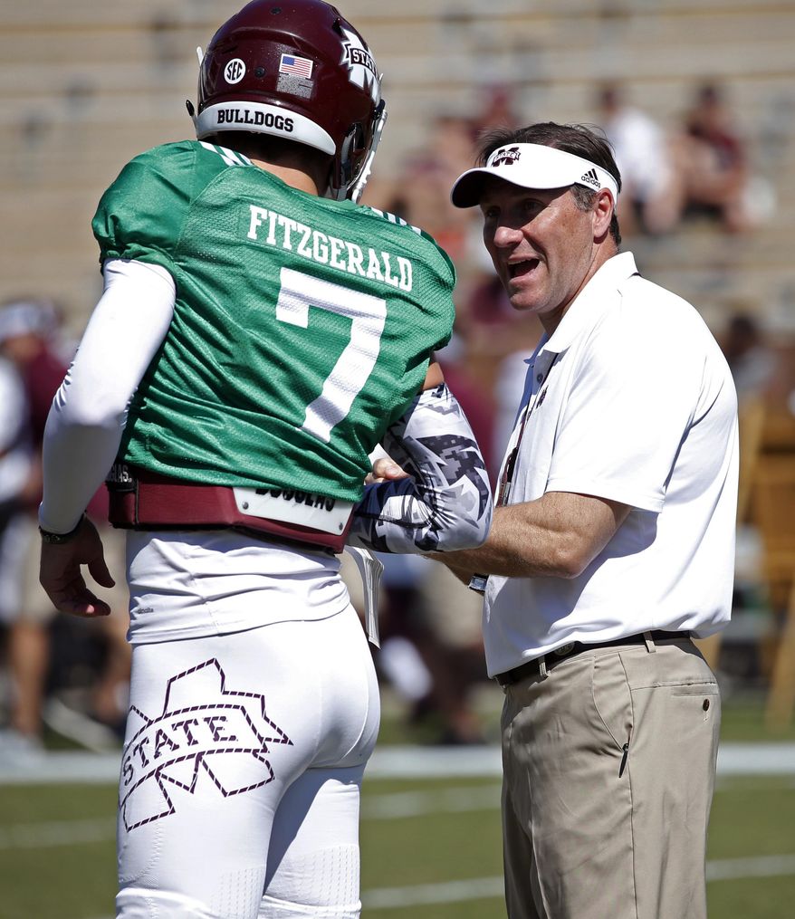 Mississippi State coach Dan Mullen speaks with Maroon quarterback Nick Fitzgerald (7) after he threw a first-quarter interception in the team's Maroon and White spring NCAA college football game, Saturday, April 8, 2017, in Starkville, Miss. White won 21-10. (AP Photo/Rogelio V. Solis)