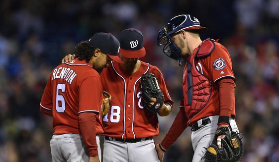 Washington Nationals&#39; Anthony Rendon (6) and Matt Wieters, right, talk with starting pitcher Jeremy Guthrie, center, during the first inning of a baseball game against the Philadelphia Phillies, Saturday, April 8, 2017, in Philadelphia. (AP Photo/Derik Hamilton)