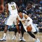 Denver Nuggets guard Jamal Murray, front, is fouled by New Orleans Pelicans guard Jrue Holiday, back right, as he tries to make his way past a pick set by Nuggets forward Kenneth Faried during the second half of an NBA basketball game Friday, April 7, 2017, in Denver. The Nuggets won 122-106. (AP Photo/David Zalubowski)