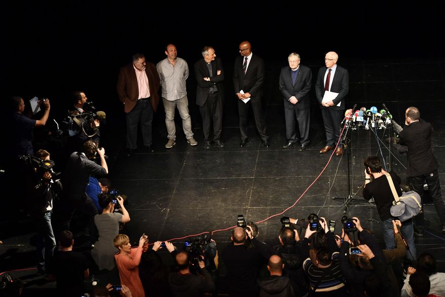 Ram Manikkalingam, third right, president of the Verification Commission for disarmament of ETA, the Basque separatist group, poses for the media with French Mayor of Bayonne Jean-Rene Etchegaray, right, and other members of the Verification Commission ahead of announcing that ETA handed over its arms in Bayonne, southwestern France, Saturday, April 8, 2017. The Basque separatist group ETA, inactive for more than five years, handed over its arms Saturday, putting a finishing touch to a 43-year violent campaign that claimed the lives of over 800 people mostly in Spain. (AP Photo/Alvaro Barrientos)
