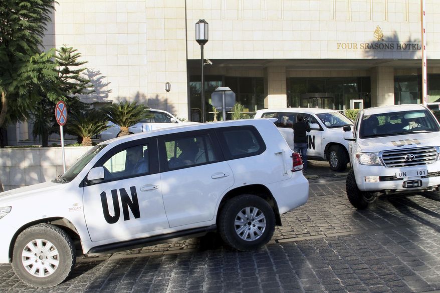 FILE -- In this Oct. 8, 2013 file photo, a convoy of chemical weapons disarmament experts depart the Four Seasons Hotel in Damascus, Syria. Assad is supposed to have declared and destroy his chemical weapon stockpile under U.N. supervision in 2014. Yet no one questioned the fact that he did, or seemed particularly surprised. (AP Photo, File)