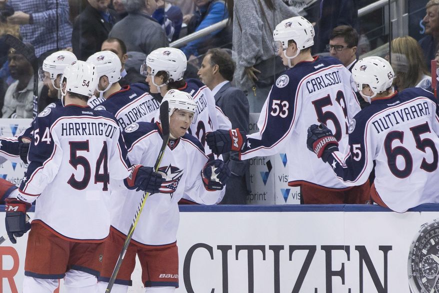 Columbus Blue Jackets' Cam Atkinson, centre left, celebrates after scoring against the Toronto Maple Leafs during second period NHL hockey action in Toronto, on Sunday, April 9, 2017. (Chris Young/The Canadian Press via AP)