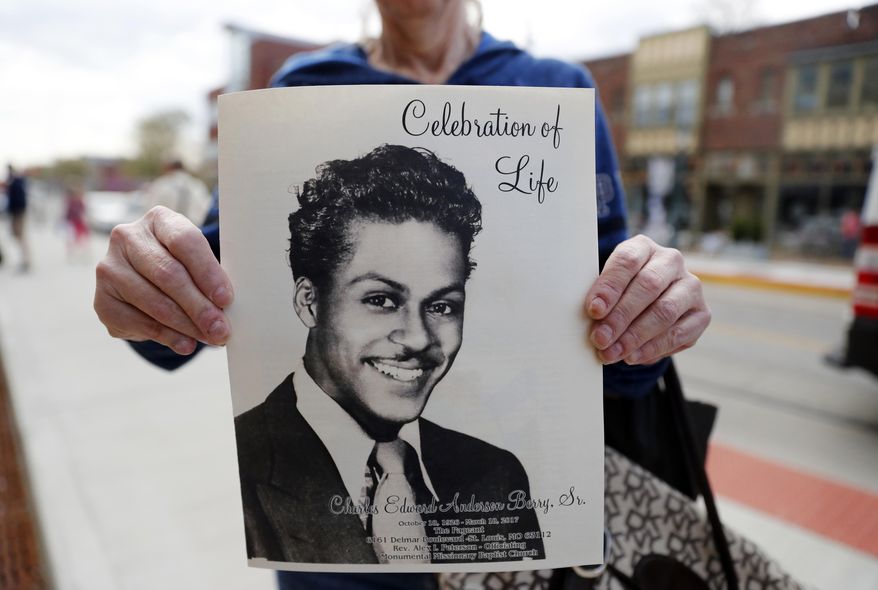A woman holds a program outside The Pageant, a concert venue where a celebration of life is set to start for rock 'n' roll legend Chuck Berry and where Berry often performed, Sunday, April 9, 2017, in St. Louis. The man behind such classics as "Johnny B. Goode," ''Sweet Little Sixteen" and "Roll Over Beethoven" died on March 18 at the age of 90. (AP Photo/Jeff Roberson)