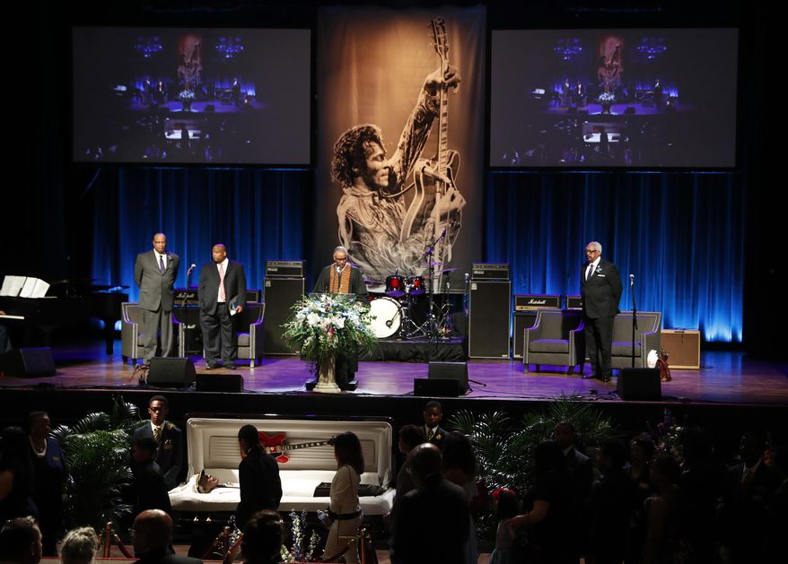 Family and friends slowly walk past the casket of rock 'n' roll legend Chuck Berry at the start of his celebration of life Sunday, April 9, 2017, in St. Louis. The man behind such classics as "Johnny B. Goode," ''Sweet Little Sixteen" and "Roll Over Beethoven" died on March 18 at the age of 90. (AP Photo/Jeff Roberson)