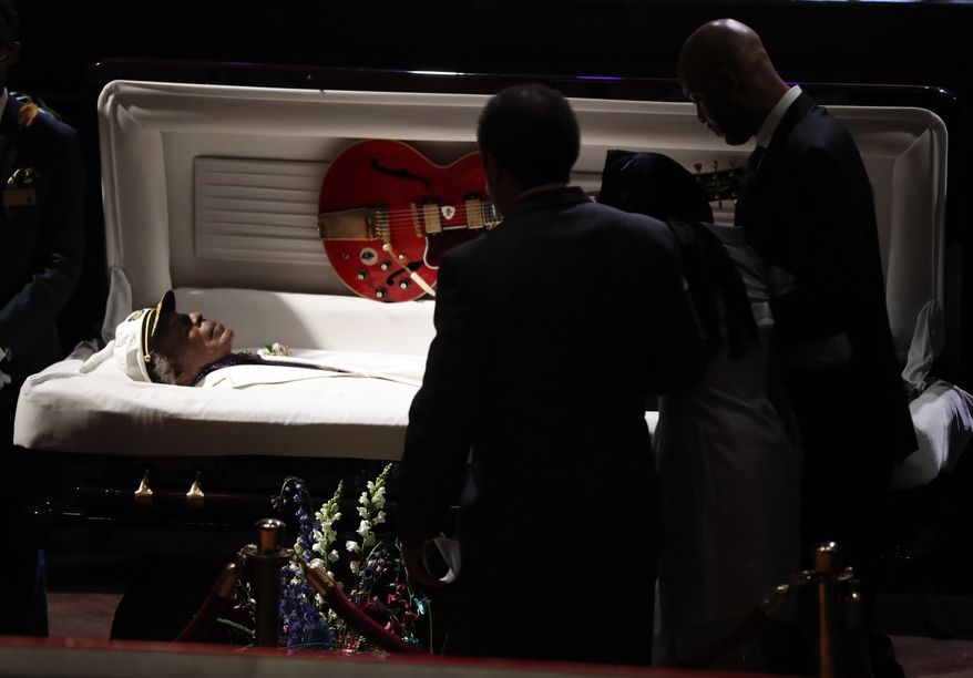 Family and friends pass by the casket of rock 'n' roll legend Chuck Berry at the start of his celebration of life private service, Sunday, April 9, 2017, in St. Louis. The man behind such classics as "Johnny B. Goode," ''Sweet Little Sixteen" and "Roll Over Beethoven" died on March 18 at the age of 90. (AP Photo/Jeff Roberson)