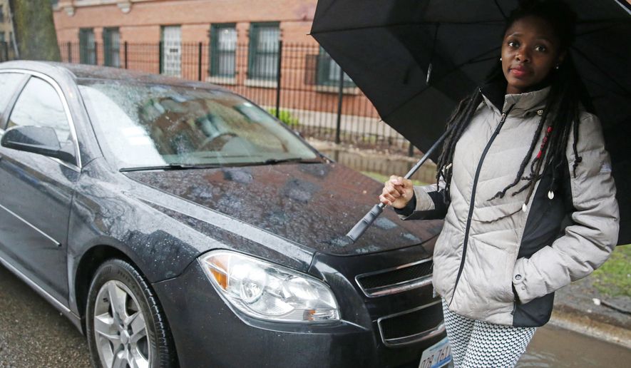 In this Wednesday, April 5, 2017 photo, Kara Bland stands in front of her car in Chicago. Bland’s 2010 Chevy Malibu still had temporary plates when police seized it for a crime she did not commit. She loaned it to the father of her daughter, who was arrested after picking up someone who had marijuana on him. For six weeks, Bland took her daughter to school on a Chicago city bus and relatives helped her run errands before a judge released the car on bond. It took a total of nine months to officially regain ownership and cost her $1,000. (AP Photo/Nam Y. Huh)
