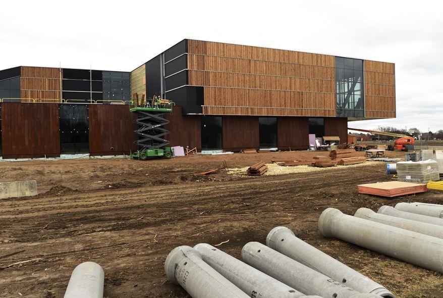 Workers install white pine siding on the new $64.2 milllion Bell Museum of Natural History, under construction in St. Paul, Minn. on Thursday, March 30, 2017. The new facility, which will replace the old museum built in 1940, is set to open early summer of 2018. (Scott Takushi /Pioneer Press via AP)