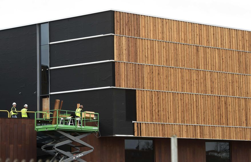 Workers install white pine siding on the new $64.2 milllion Bell Museum of Natural History, under construction in St. Paul, Minn. on Thursday, March 30, 2017. The new facility, which will replace the old museum built in 1940, is set to open early summer of 2018. (Scott Takushi /Pioneer Press via AP)