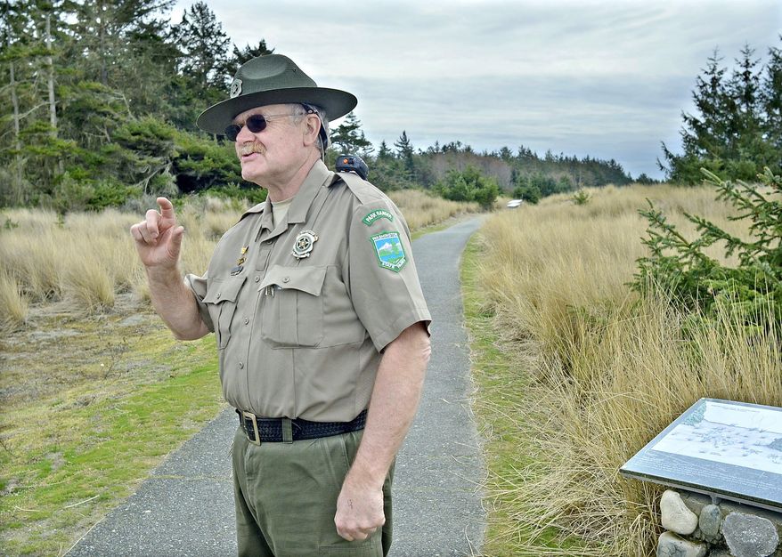 In this March 20, 2017, photo, retiring assistant park manager at Deception Pass State Park, Rick Blank talks about the interpretive trail at the south end of West Beach in Washington. Blank has been an employee of Washington State Parks for 45 years and is the longest-tenured ranger in the field, he arrived at Deception Pass in 1990. (Scott Terrell/Skagit Valley Herald via AP)